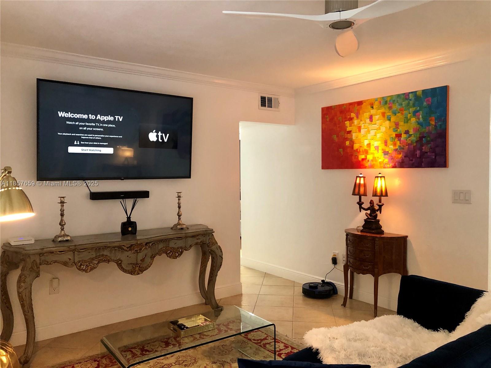 6450 Southwest 19th Street West Miami, FL 33155 - Photo 18 of 42 a room with table chairs and a flat screen tv