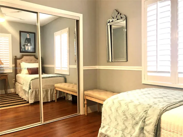 a bed sitting in a bedroom next to a window with outer view