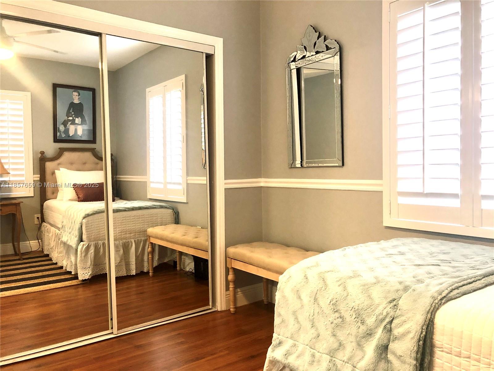 6450 Southwest 19th Street West Miami, FL 33155 - Photo 20 of 42 a bedroom with a bed and wooden floor