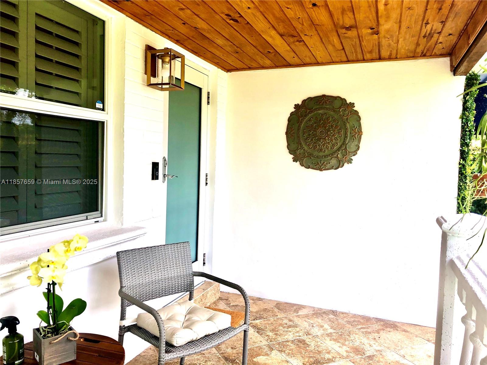 6450 Southwest 19th Street West Miami, FL 33155 - Photo 2 of 42 a backyard of a house with table and chairs