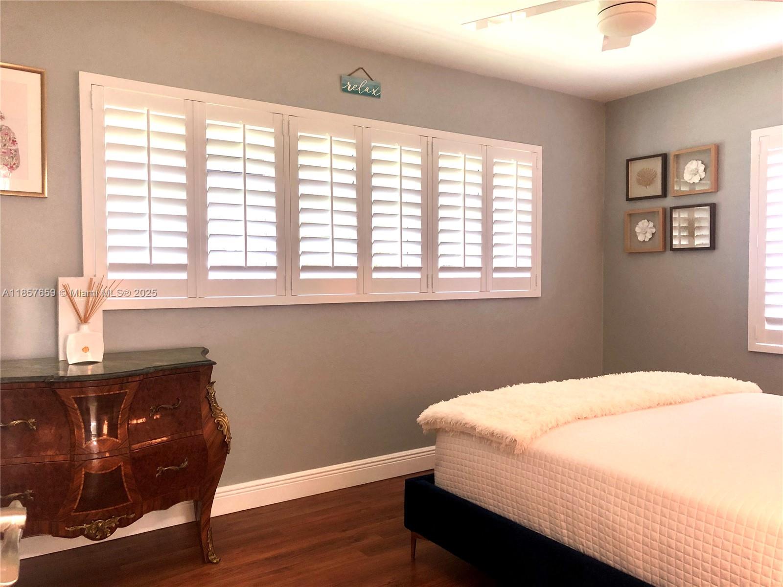 6450 Southwest 19th Street West Miami, FL 33155 - Photo 23 of 42 a bedroom with a bed and wooden floor