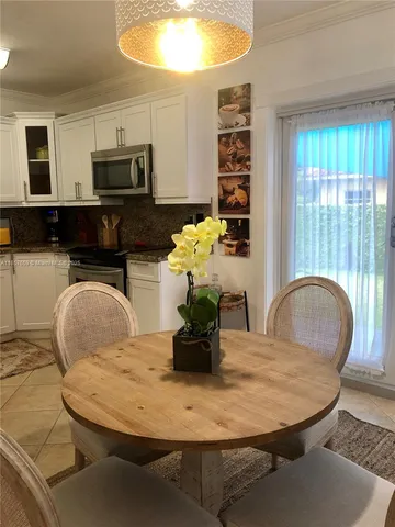 a kitchen with stainless steel appliances kitchen island granite countertop a refrigerator a stove and a sink