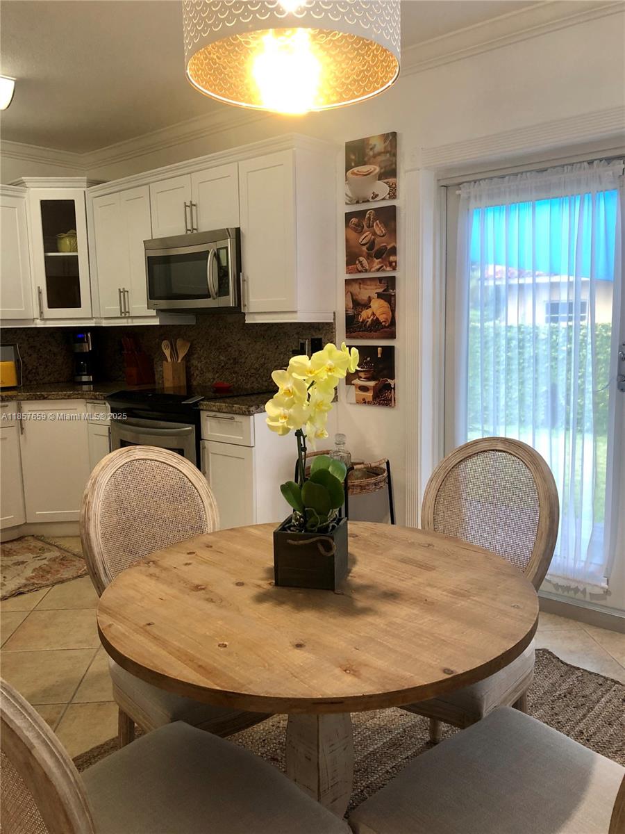 6450 Southwest 19th Street West Miami, FL 33155 - Photo 26 of 42 a dining table with chairs and a dining table