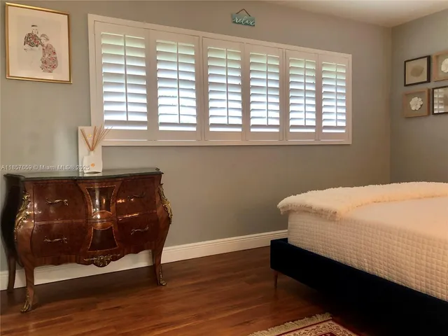 a kitchen with stainless steel appliances kitchen island granite countertop a refrigerator a stove a sink a counter space and cabinets