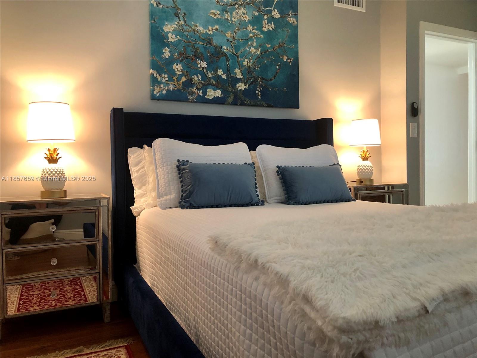 6450 Southwest 19th Street West Miami, FL 33155 - Photo 31 of 42 a large bed sitting in a bedroom next to a lamp