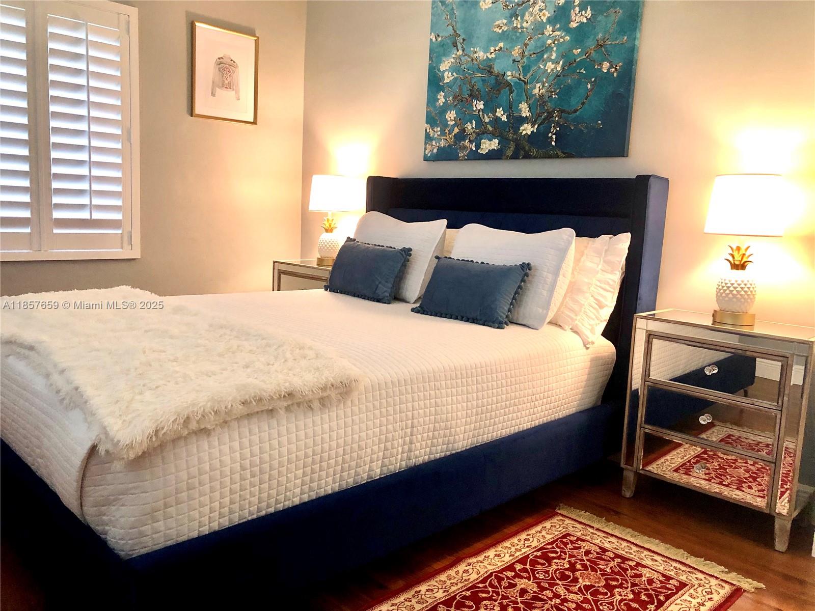 6450 Southwest 19th Street West Miami, FL 33155 - Photo 32 of 42 a bed sitting in a bedroom next to a window with a lamp