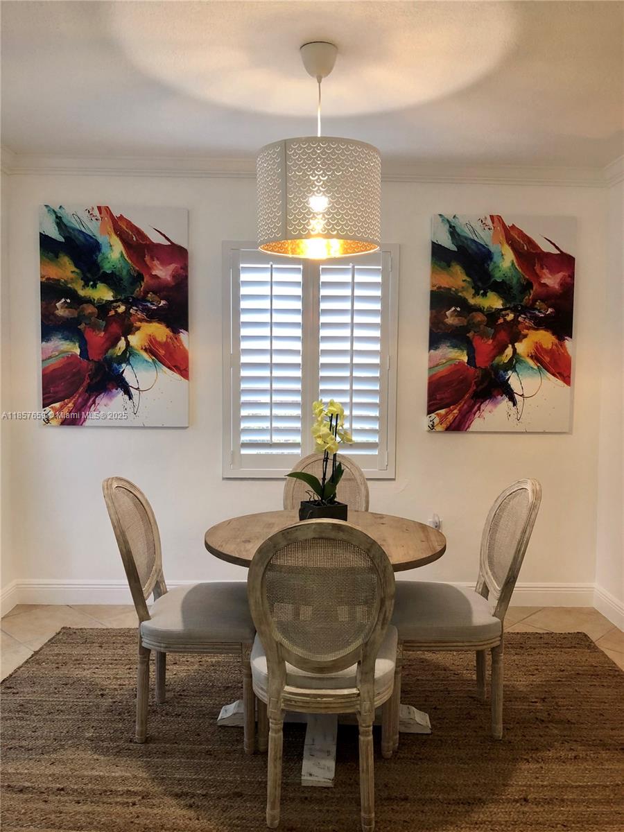 6450 Southwest 19th Street West Miami, FL 33155 - Photo 35 of 42 a view of a dining room with furniture wooden floor and a chandelier