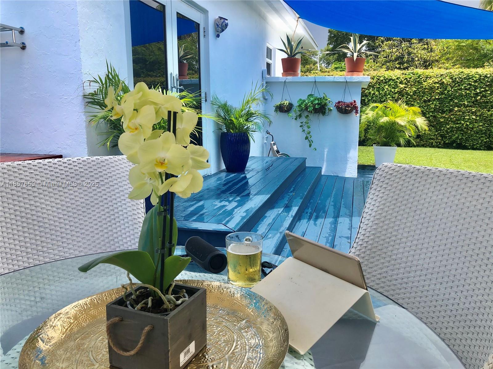 6450 Southwest 19th Street West Miami, FL 33155 - Photo 40 of 42 a vase of flowers sitting on a table with chairs