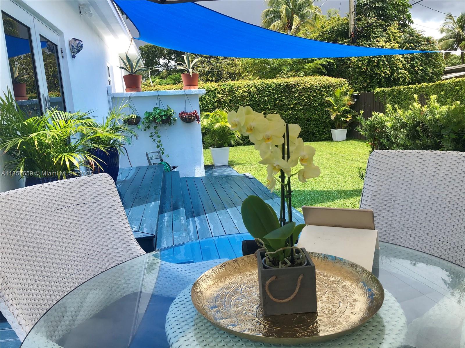 6450 Southwest 19th Street West Miami, FL 33155 - Photo 41 of 42 a view of a dining room with furniture a potted plant and wooden floor