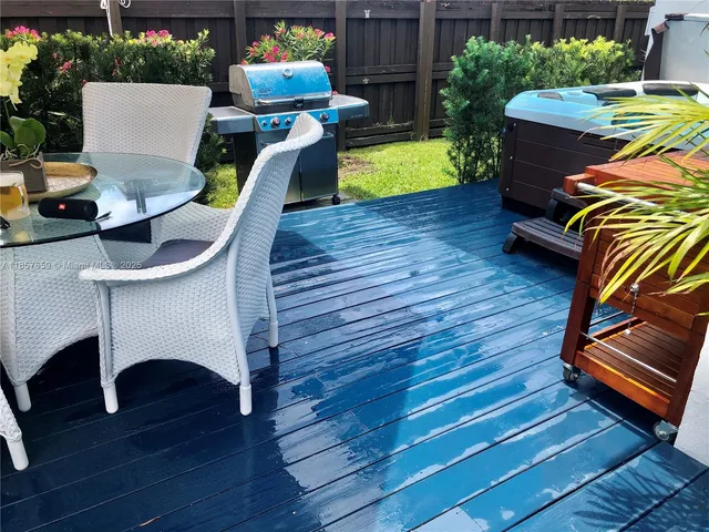 a view of a chairs and table in backyard