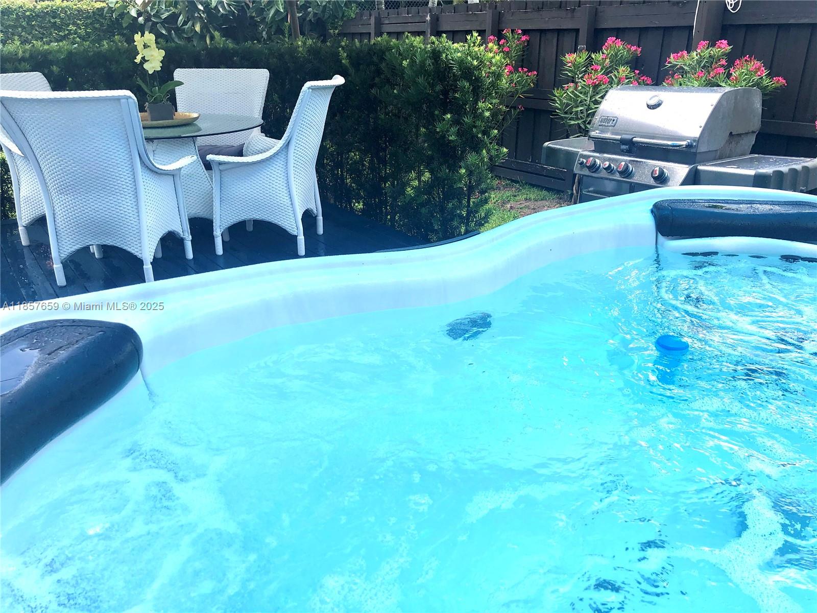 6450 Southwest 19th Street West Miami, FL 33155 - Photo 9 of 42 a view of a chairs and table in backyard