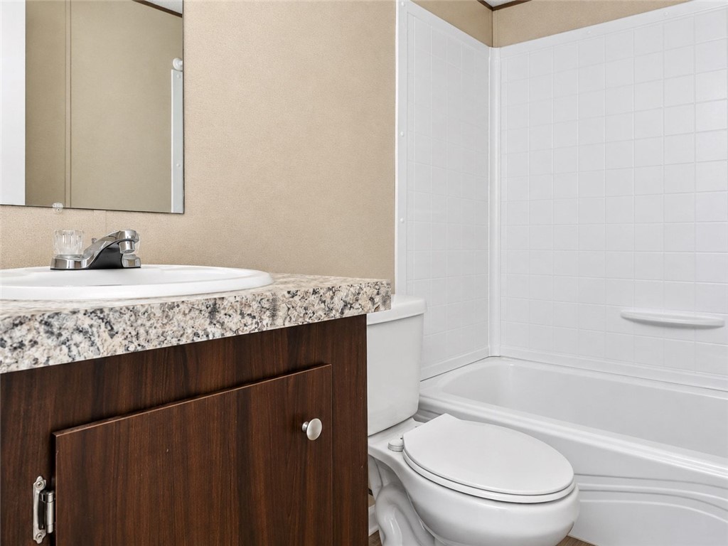 1309 Big Creek Road Belton, SC 29627 - Photo 15 of 21 Clean lines and stone-patterned counters define this functional bathroom layout with integrated tub.