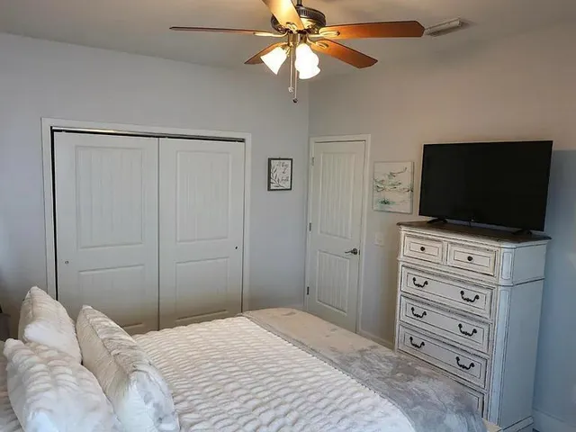 a bedroom with a bed and a mirror