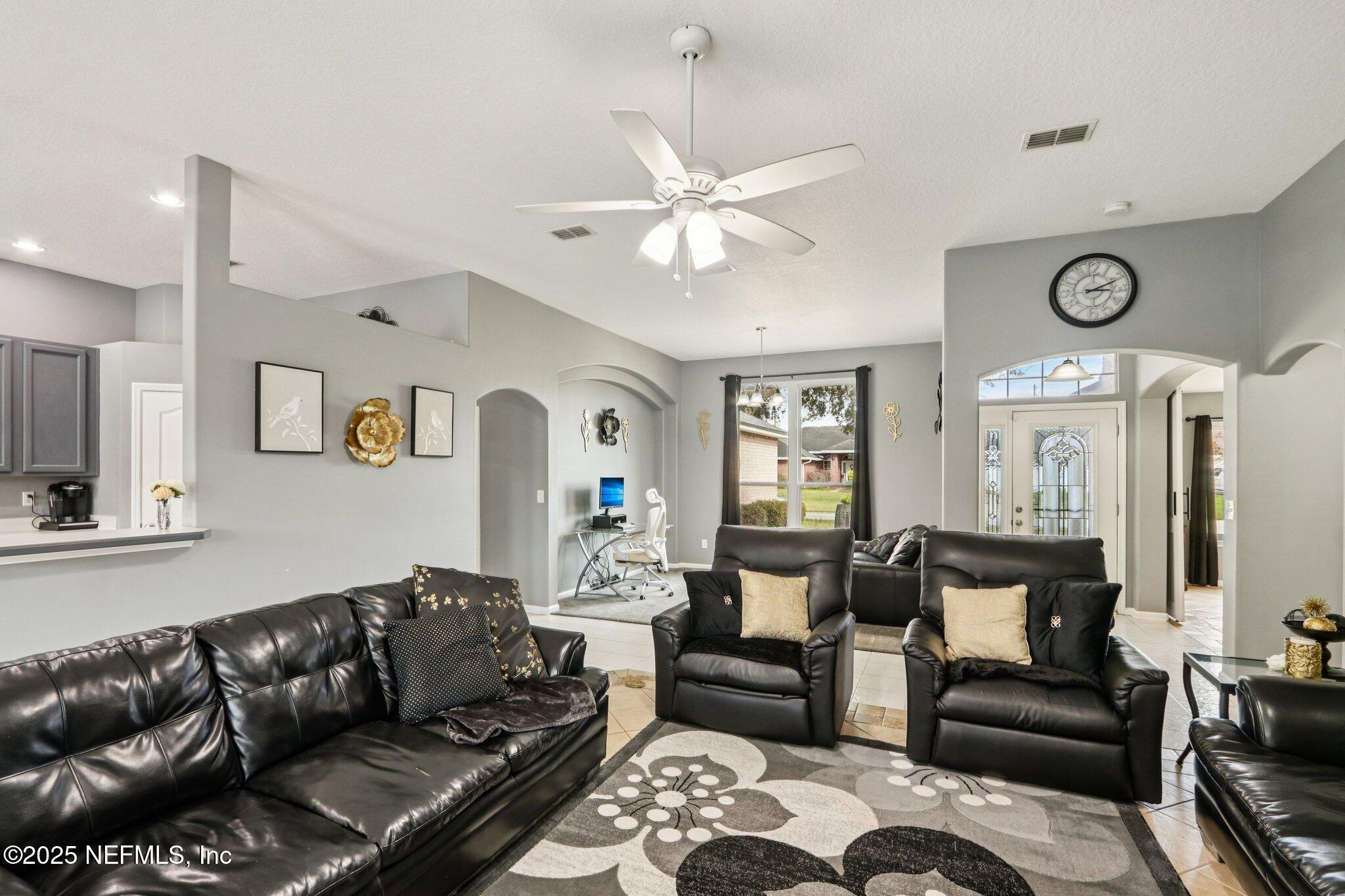 2390 Mallory Hills Road Jacksonville, FL 32221 - Photo 19 of 42 a living room with furniture ceiling fan and a rug