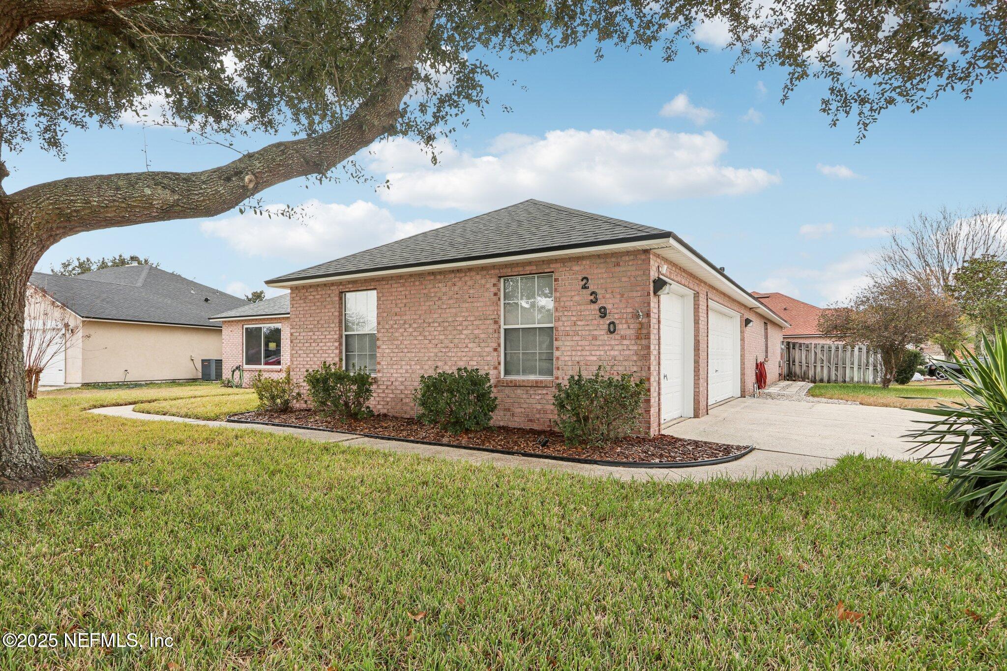 2390 Mallory Hills Road Jacksonville, FL 32221 - Photo 41 of 42 a front view of house with yard and green space