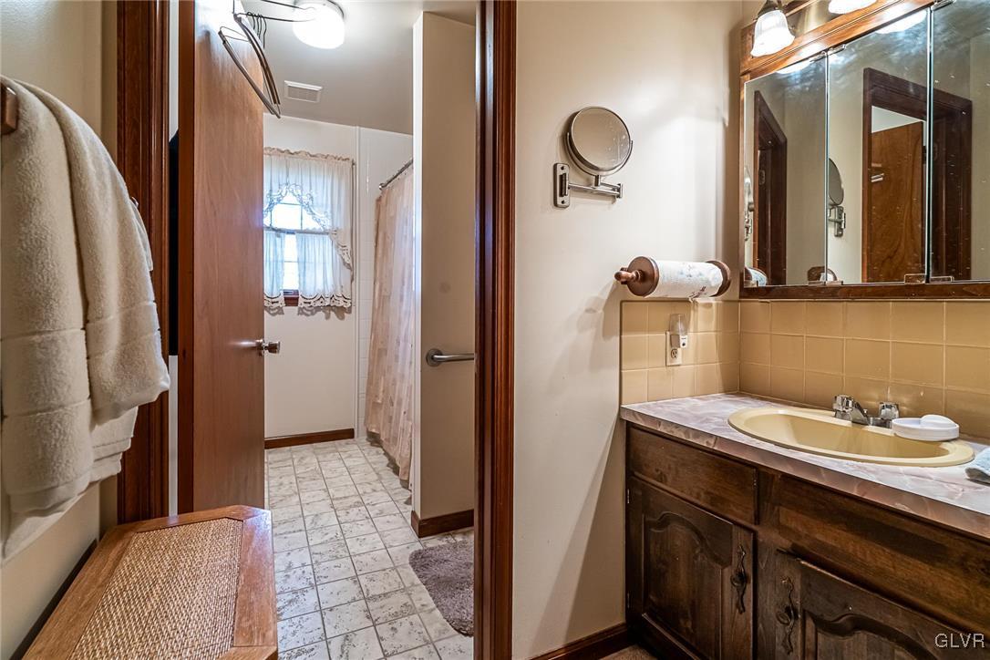 179 Kemmerer Road Nazareth, PA 18064 - Photo 23 of 38 a bathroom with a sink a mirror and shower