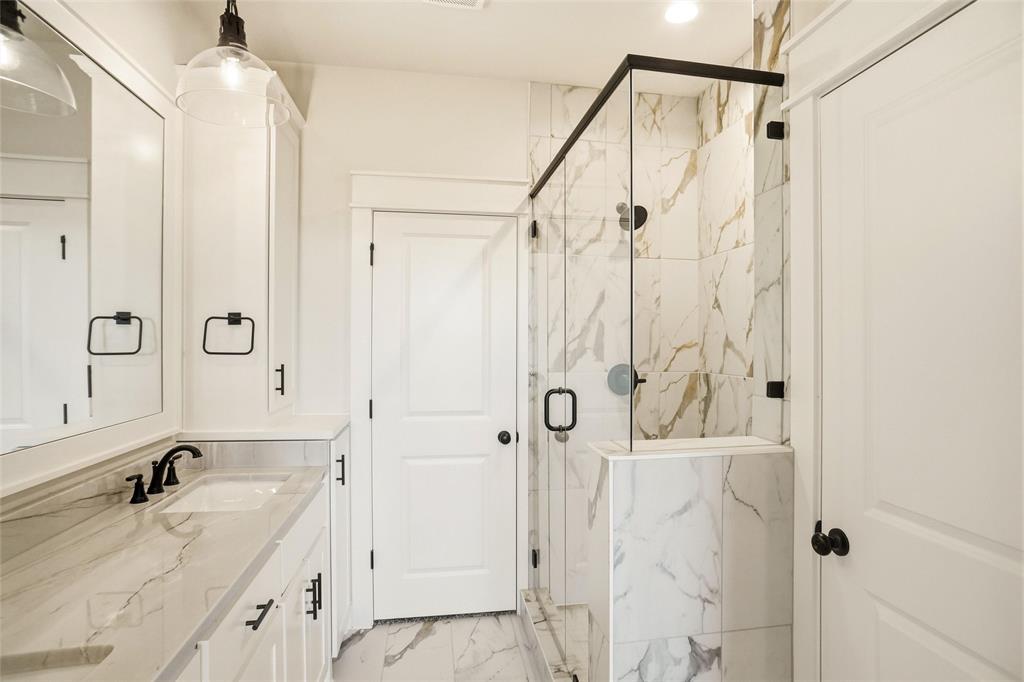 206 Legacy Boulevard Weatherford, TX 76086 - Photo 14 of 21 a bathroom with a granite countertop shower sink vanity and mirror