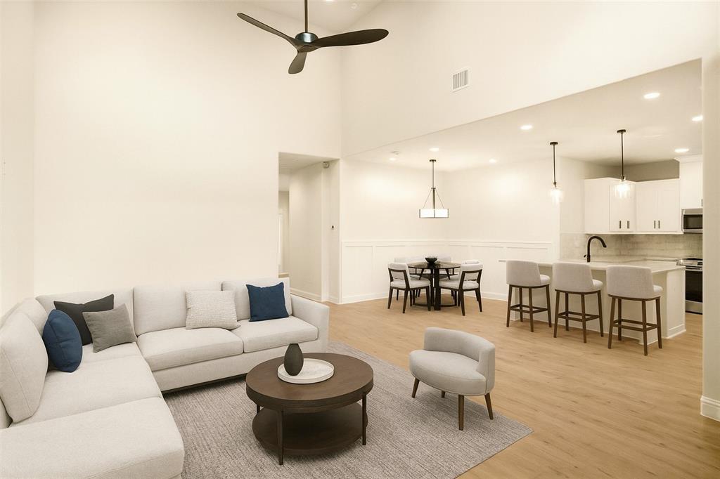 206 Legacy Boulevard Weatherford, TX 76086 - Photo 2 of 21 a living room with furniture and a dining table with wooden floor