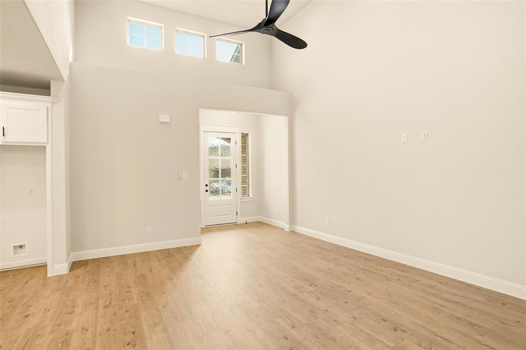 206 Legacy Boulevard Weatherford, TX 76086 - Photo 4 of 21 a view of an empty room with wooden floor and a window