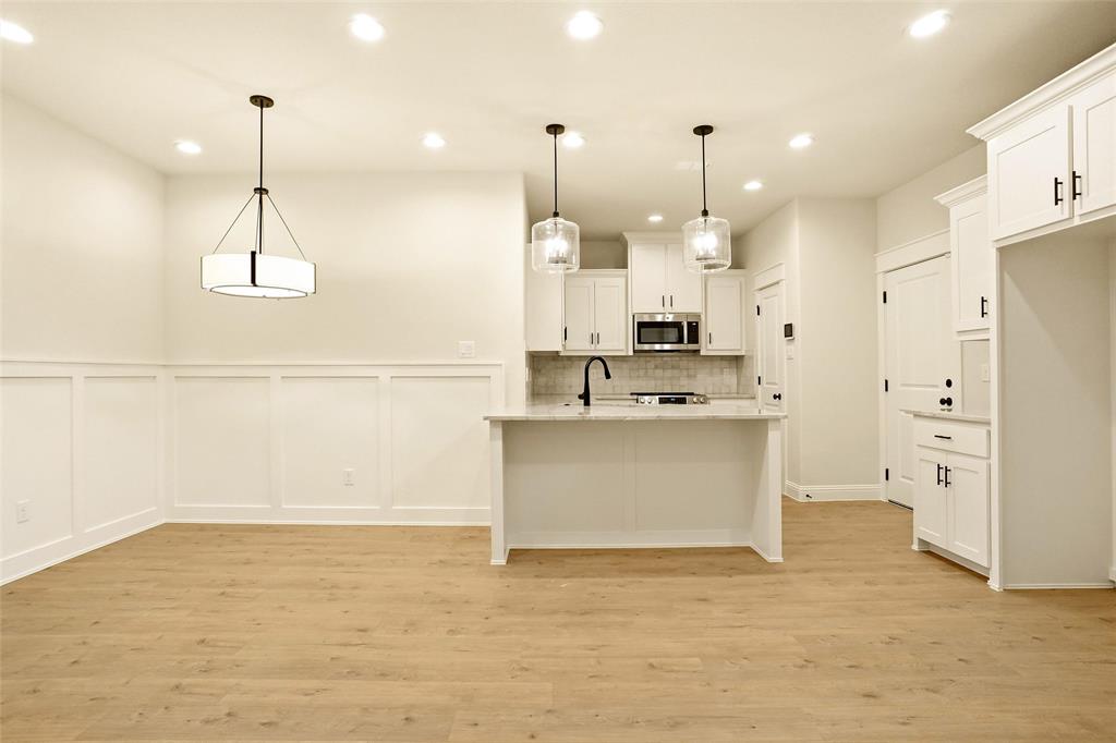 206 Legacy Boulevard Weatherford, TX 76086 - Photo 5 of 21 a view of kitchen with stainless steel appliances granite countertop cabinets and a chandelier