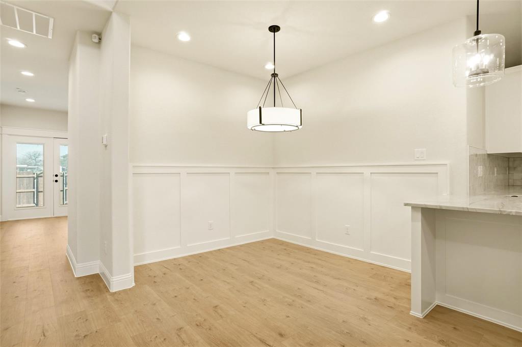 206 Legacy Boulevard Weatherford, TX 76086 - Photo 7 of 21 an empty room with kitchen view and wooden floor
