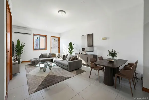 a living room with furniture potted plant and a window