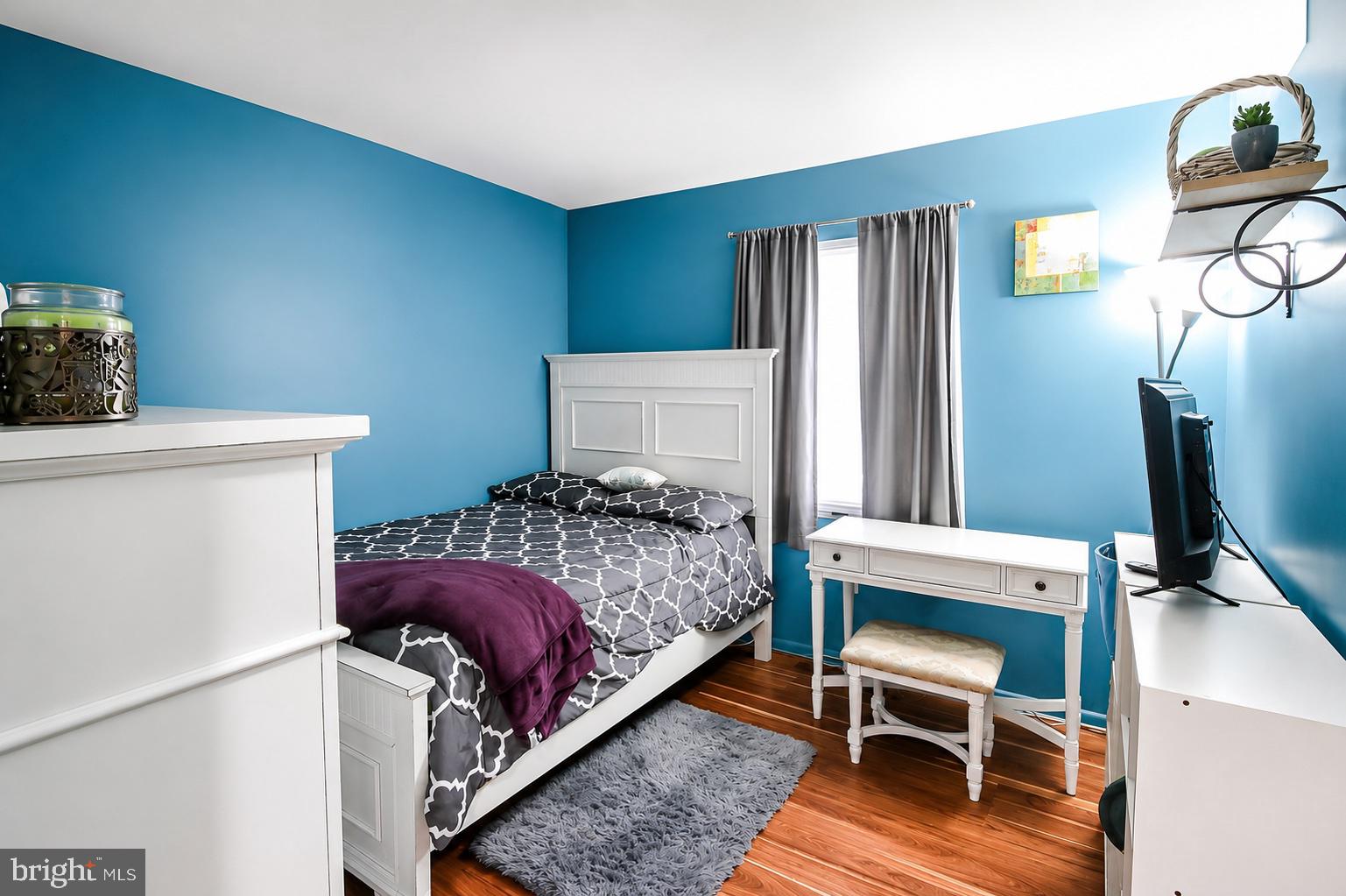 8121 Elizabeth Road Pasadena, MD 21122 - Photo 14 of 27 a bedroom with a bed and a flat screen tv