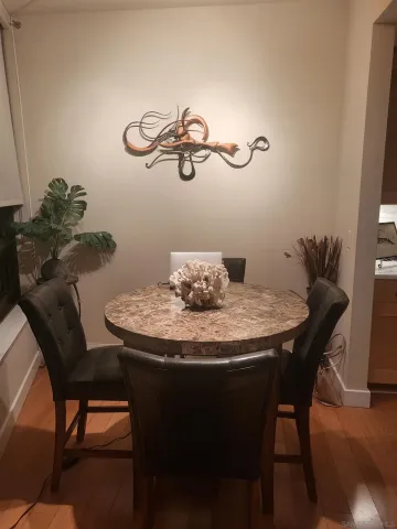 a dining room with furniture and wooden floor