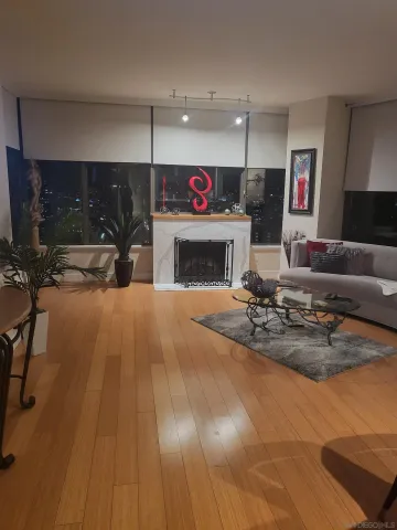 a living room with furniture a fireplace and kitchen view