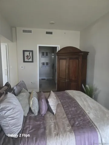 a bedroom with a bed and a mirror