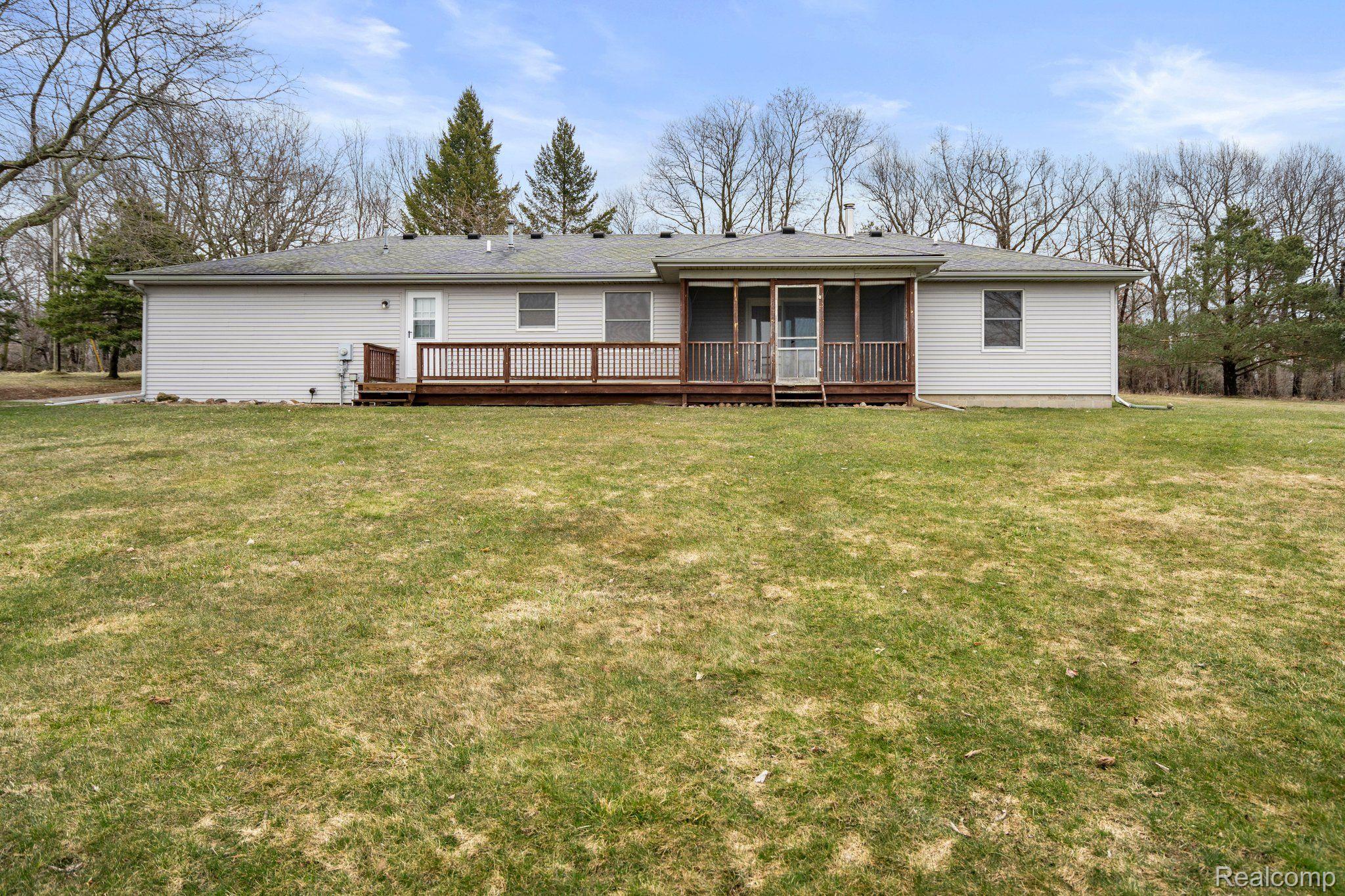 320 South Truhn Road Fowlerville, MI 48836 - Photo 2 of 35 Back of Home with Deck and Screened in Porch