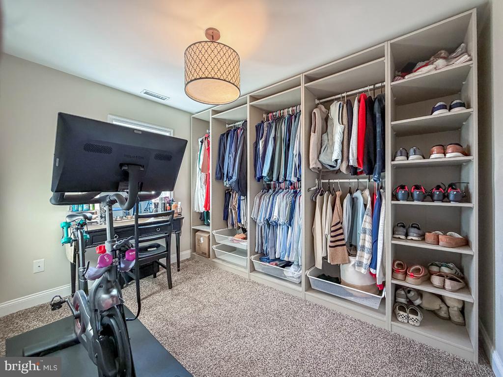 18 Jump Hill Road Levittown, PA 19056 - Photo 15 of 22 a view of walk in closet with clothes and shoes