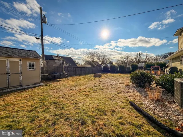 a view of a house with pool and a yard
