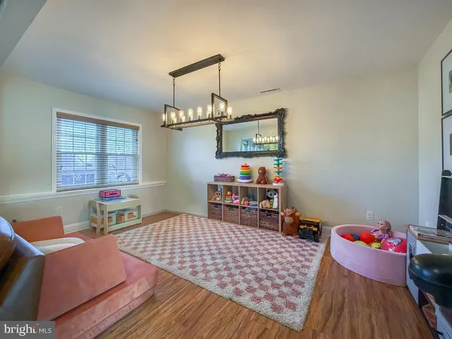 a bedroom with furniture and a wooden floor