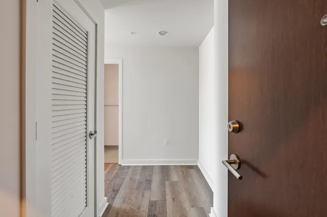 a view of workspace with window and wooden floor