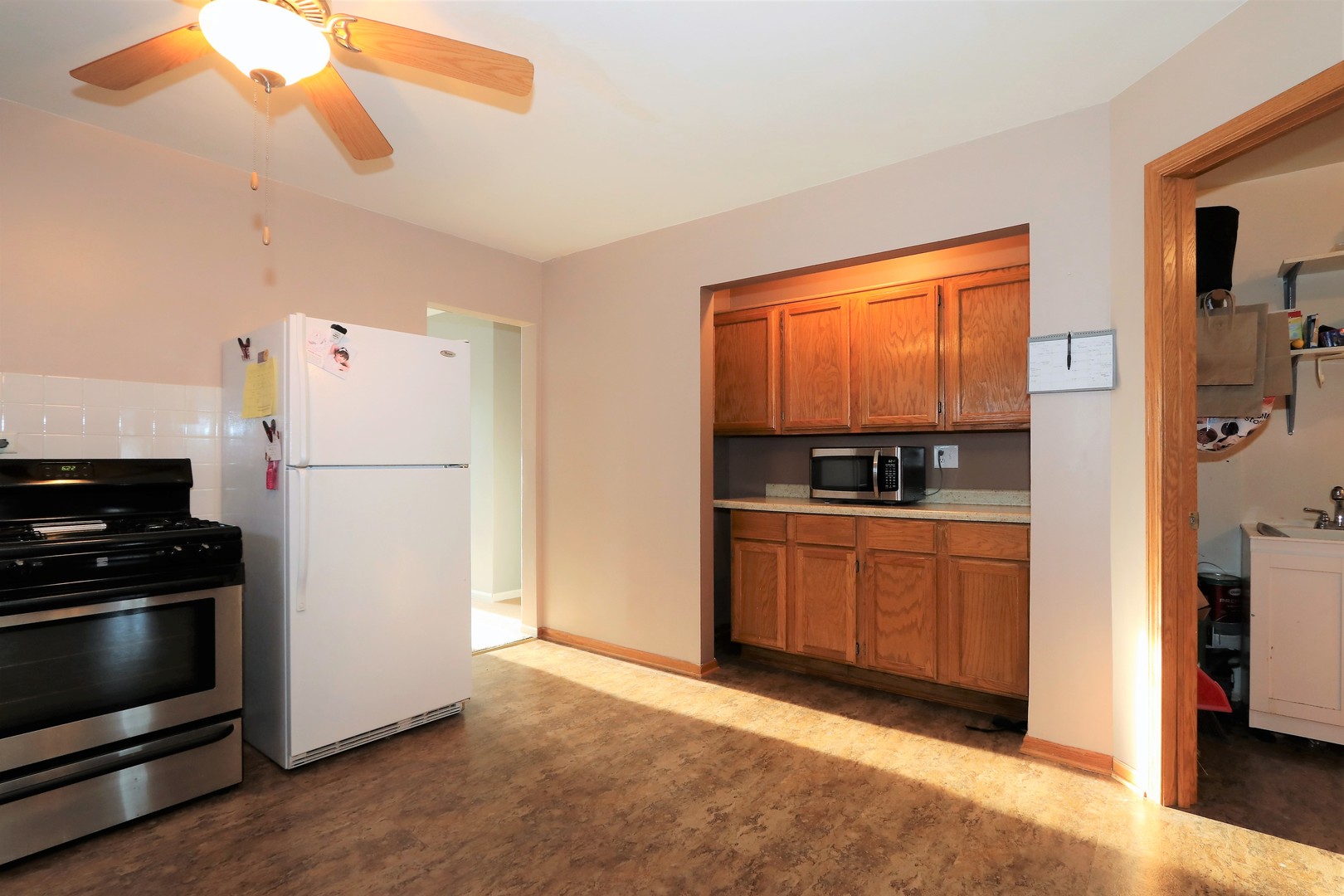 10607 Princess Avenue Chicago Ridge, IL 60415 - Photo 8 of 25 a kitchen with a refrigerator and a stove top oven