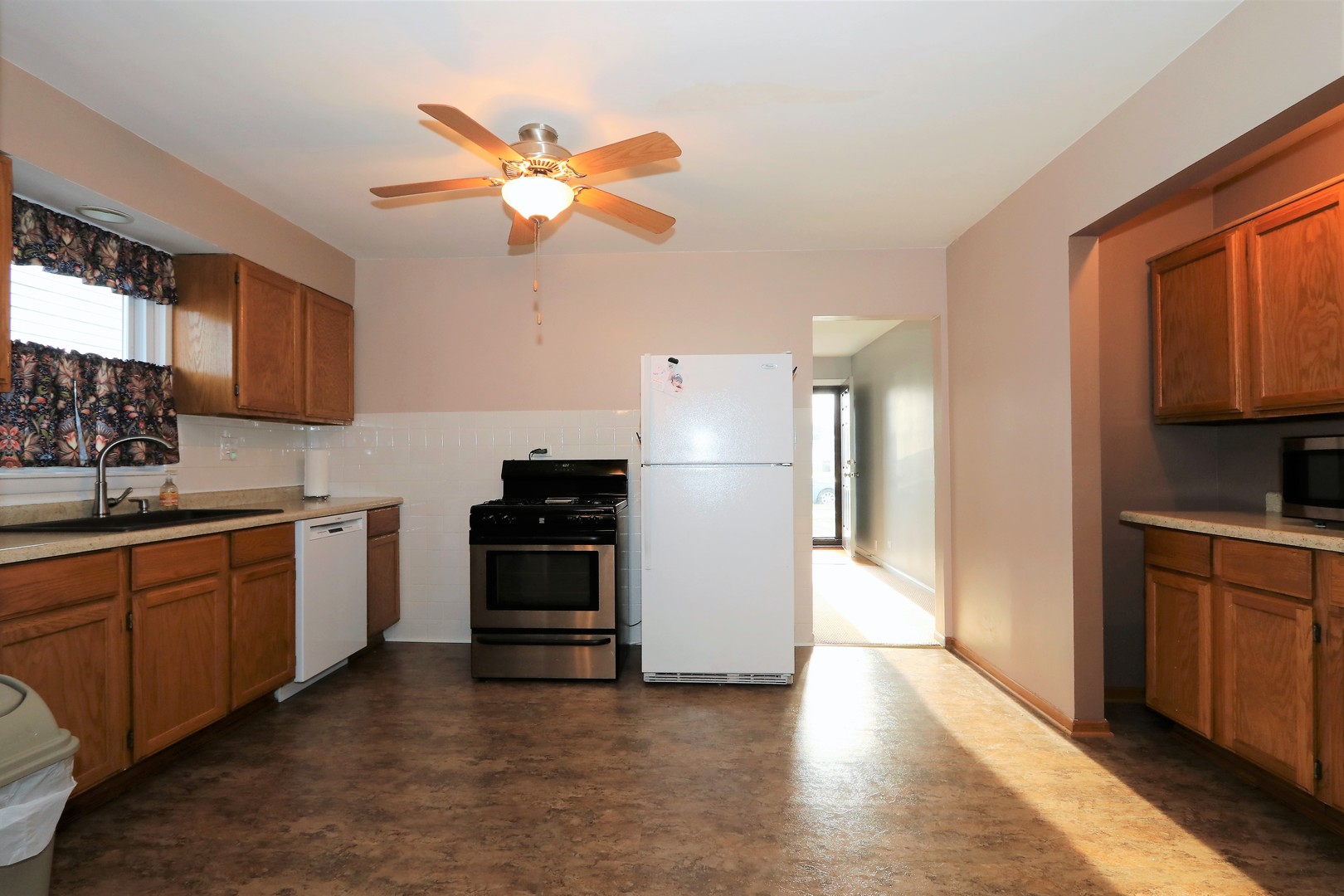 10607 Princess Avenue Chicago Ridge, IL 60415 - Photo 9 of 25 a kitchen with stainless steel appliances granite countertop a refrigerator a sink dishwasher a stove with wooden cabinets and floor