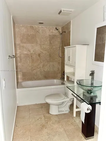 a bathroom with a sink a toilet and mirror