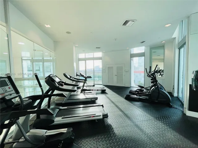 a room with gym equipment and a table