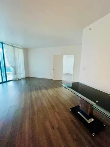 a view of kitchen with wooden floor and electronic appliances