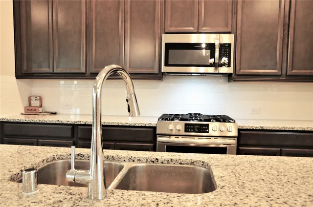 a kitchen with a stove a microwave and cabinets
