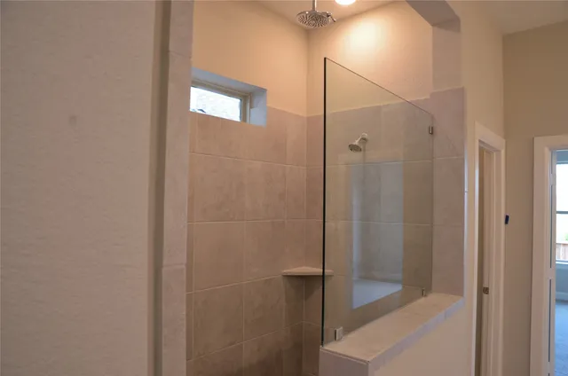 a bathroom with a shower and a mirror