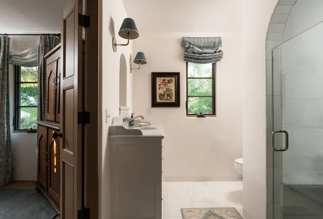 a bathroom with a sink a mirror and shower