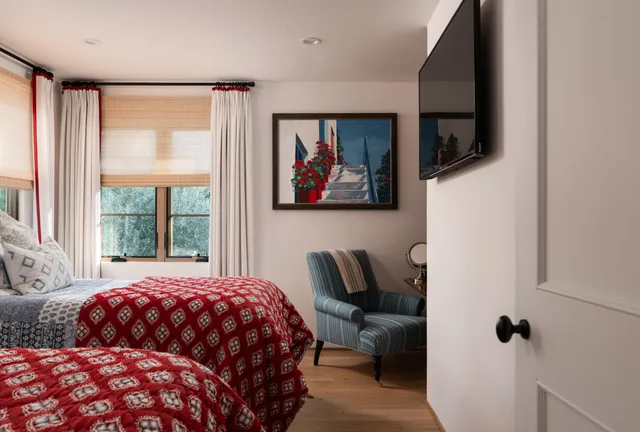 a bedroom with a bed and a painting on the wall