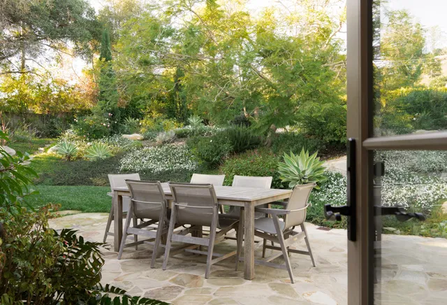 a view of a patio with a table chairs and a table