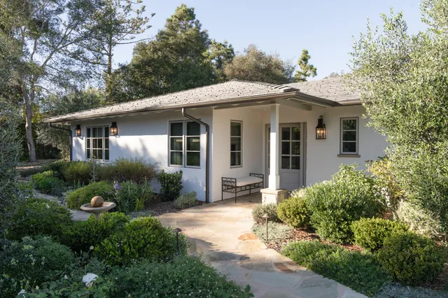 a front view of a house with garden