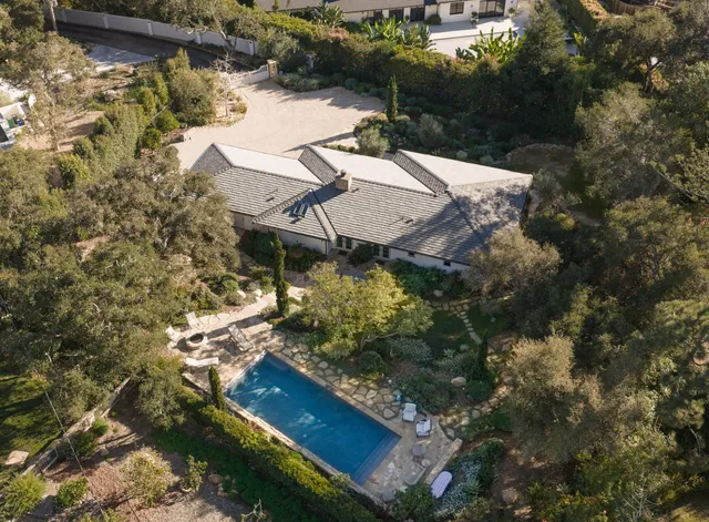an aerial view of house with yard swimming pool and outdoor seating