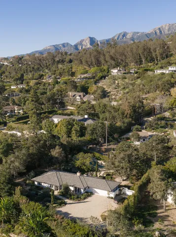 an aerial view of residential house with green space
