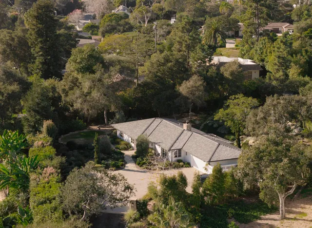 an aerial view of a house with a yard