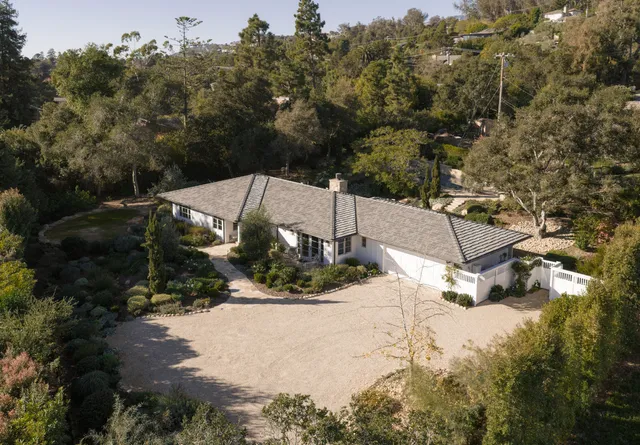 an aerial view of a house with a yard